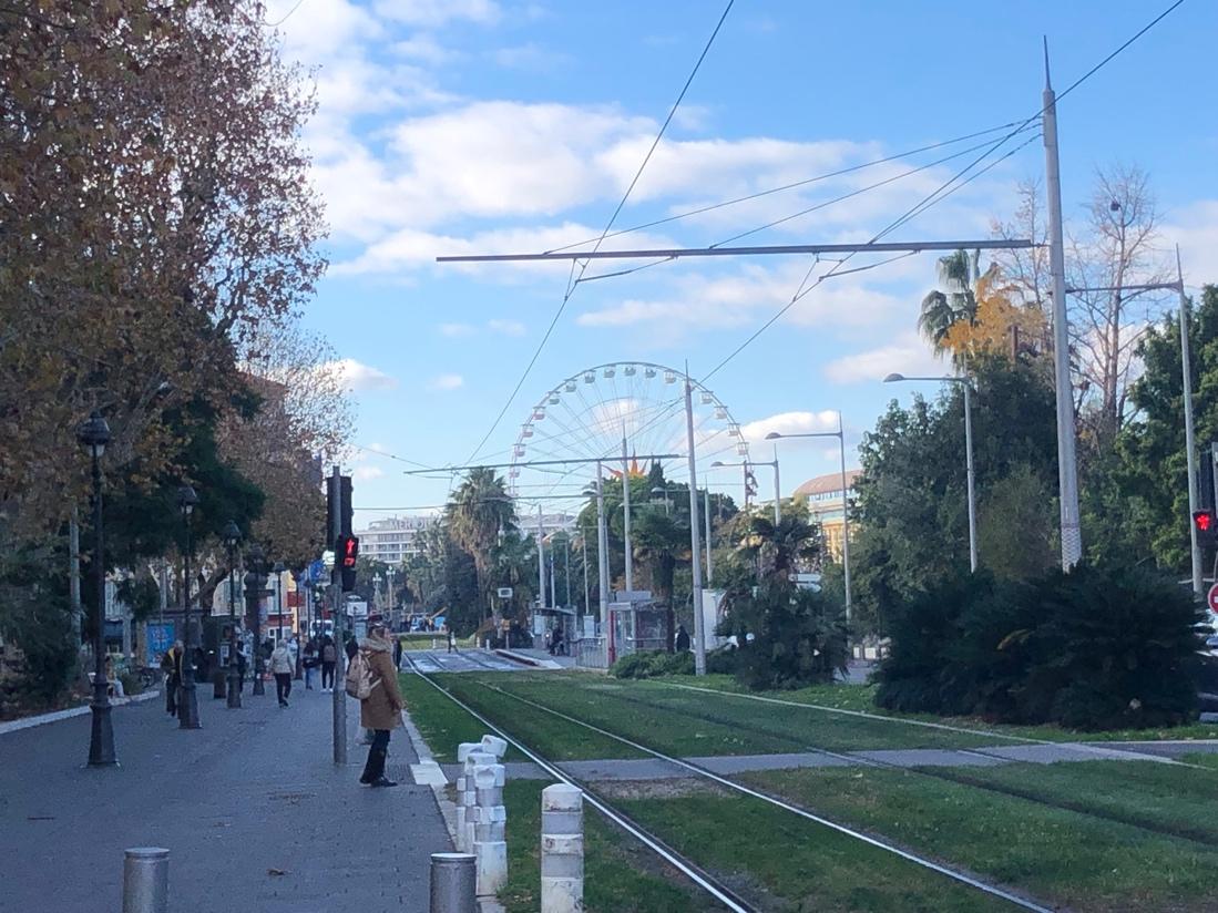 A train tracks and a ferris wheel

Description automatically generated