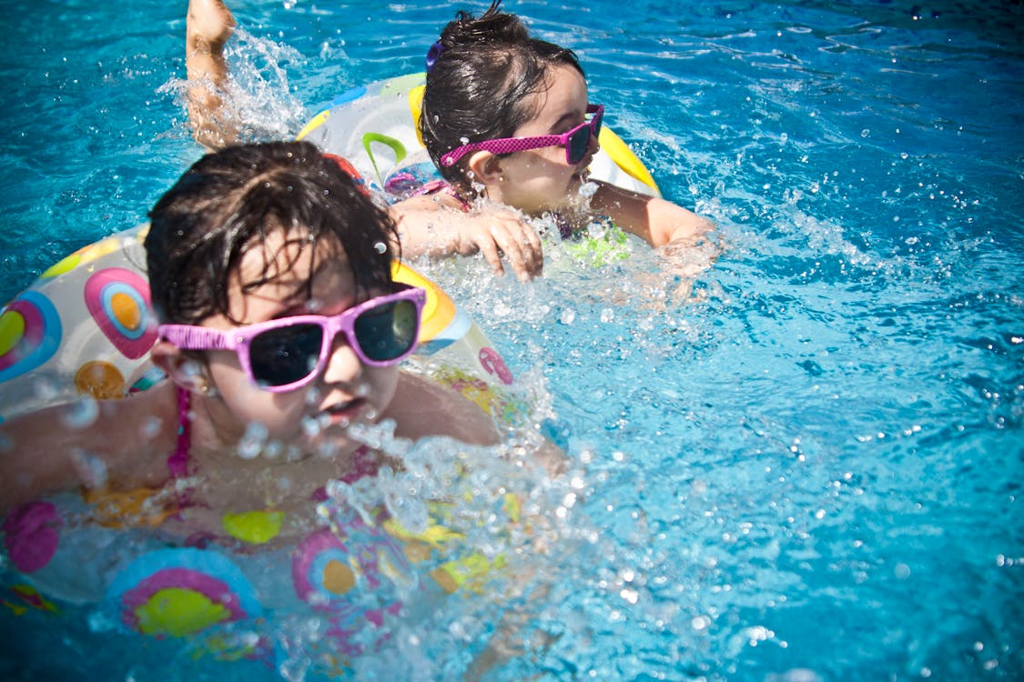 kids swimming in water during summer 