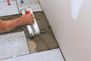 do you need a permit for a bathroom remodel in michigan remodeler laying porcelain tile flooring custom built okemos