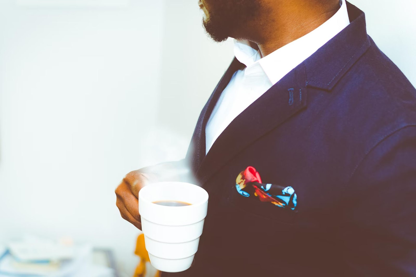 coffee snob in suit with cup