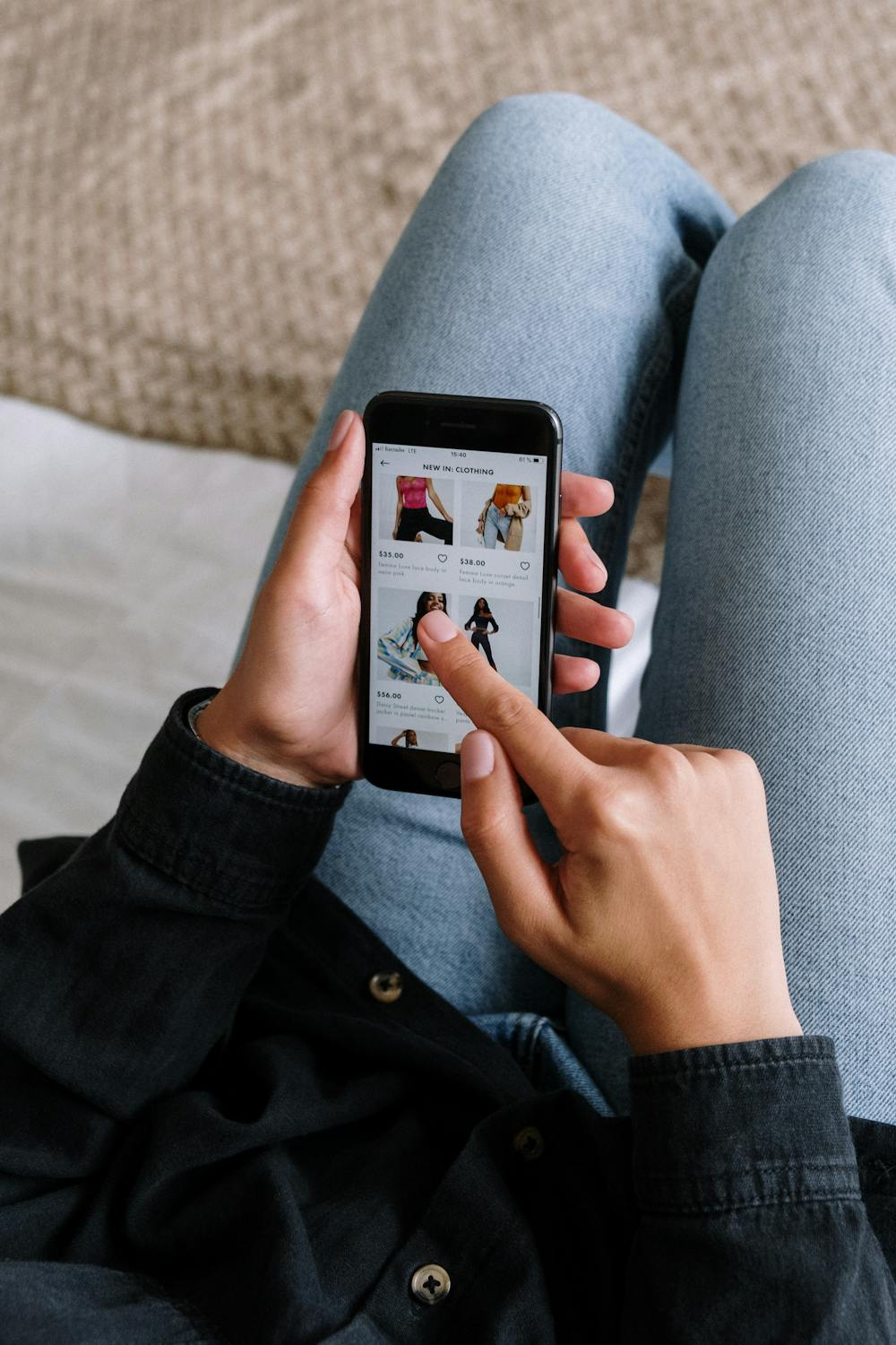 A woman shops online on her mobile phone