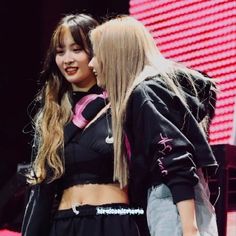 This contain a picture if sana and momo standing next to each other on stage