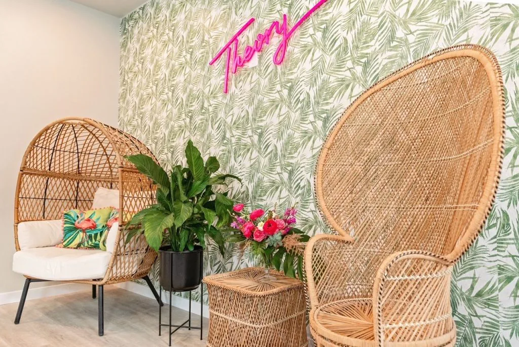 A photo of a salon selfie station with chairs and a dynamic background.