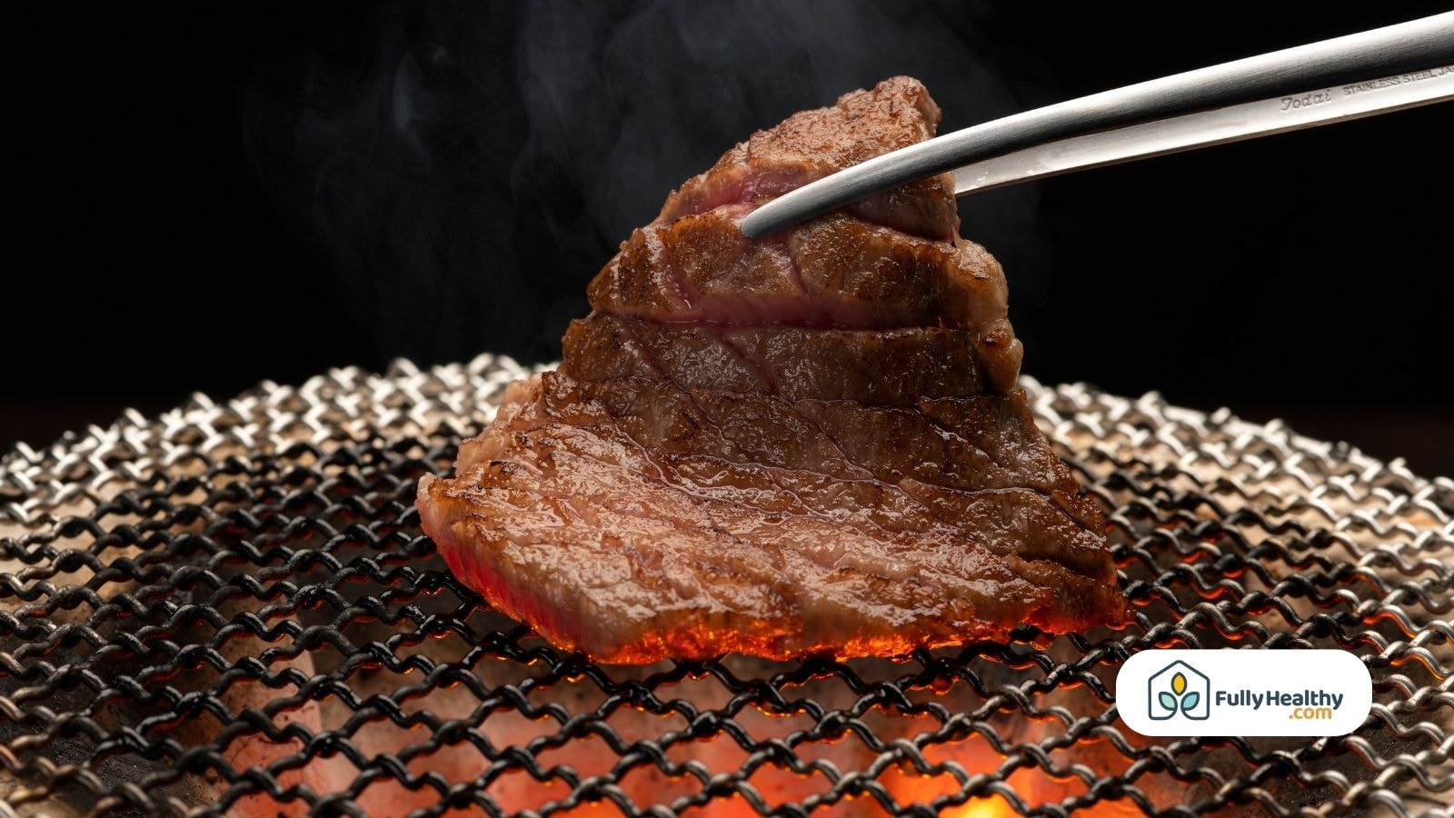 Grilled wagyu beef steak held with tongs over charcoal grill
