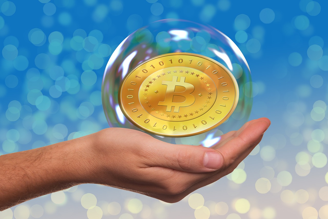 Bitcoin Coin in a bubble on someone's hand