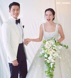 This contain Hyunbin Son Yejin   in a tuxedo standing next to a woman in a wedding dress