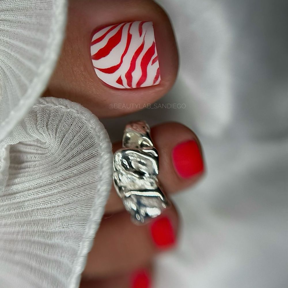 Close up of foot with radiant toe nail having Red and White