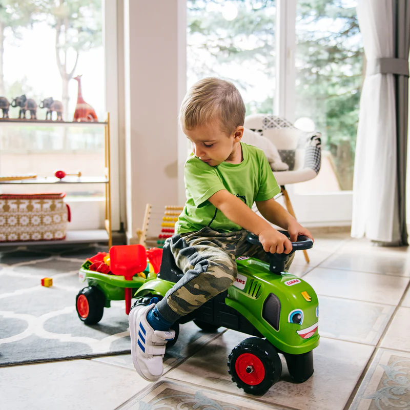 Child on toy tractor