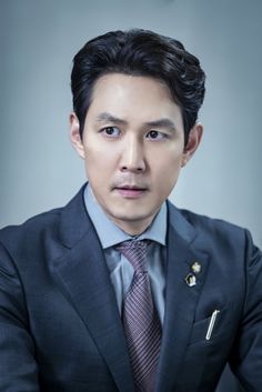 This contains an image of: Lee Jung Jae on a black suit 