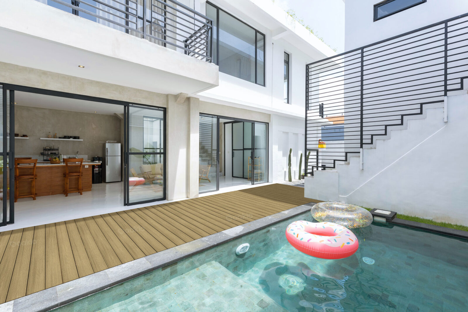 A serene pool in a two-storey house, featuring a composite pool deck system