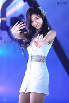 This contain an image of TWICE's Sana putting on a white dress