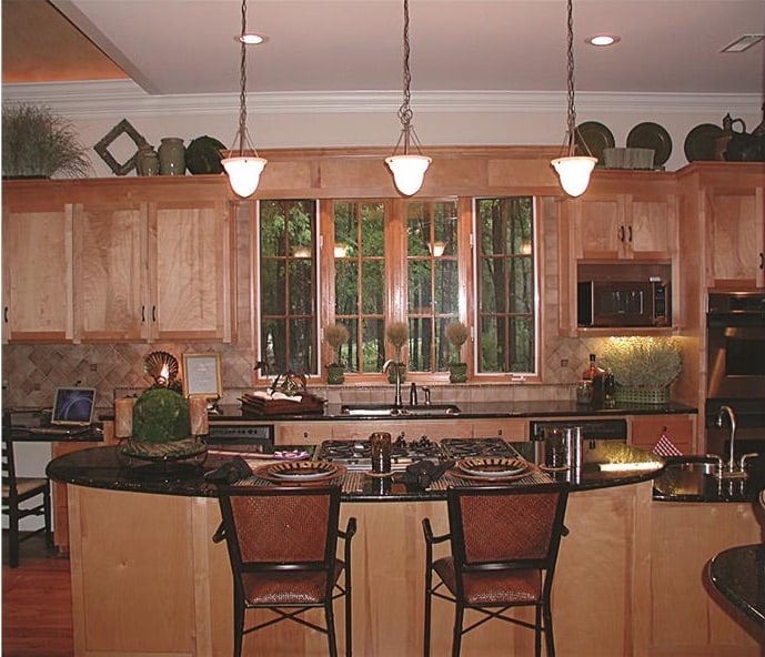 Leather counter chairs complement the kitchen island.
