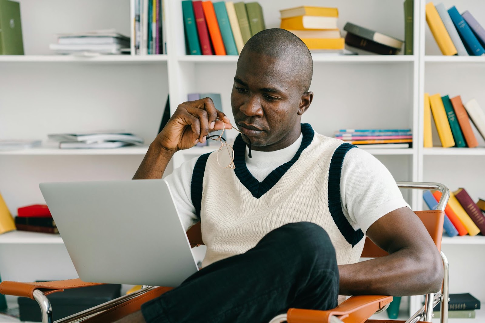 image of a man reading content from a laptop