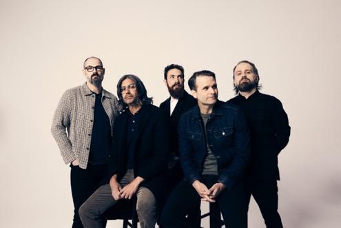 A group of men posing for a photo

Description automatically generated