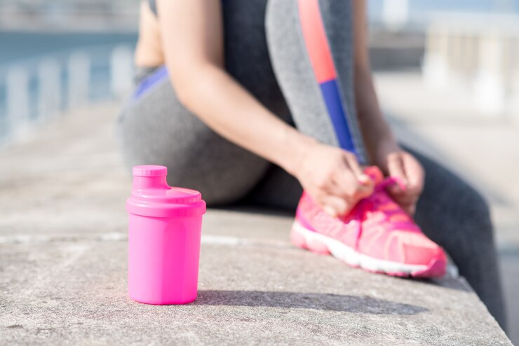 Cropped View of Woman Tying Shoelace Outdoors