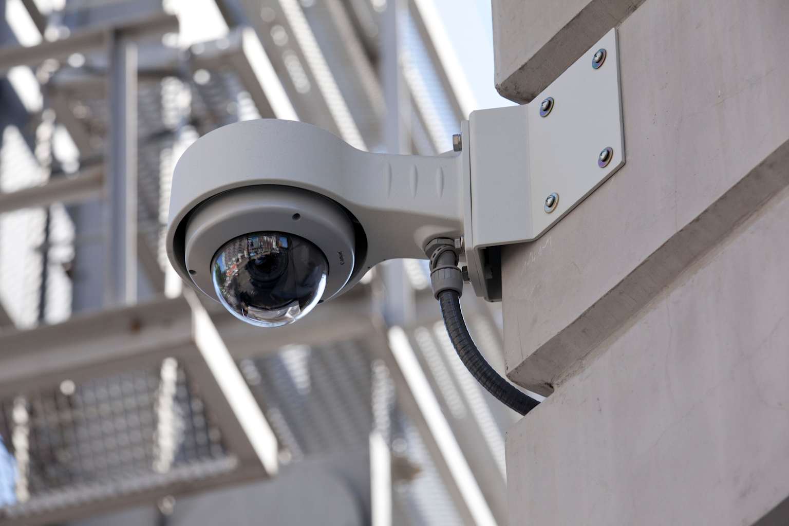 A modern dome security surveillance camera mounted outdoors