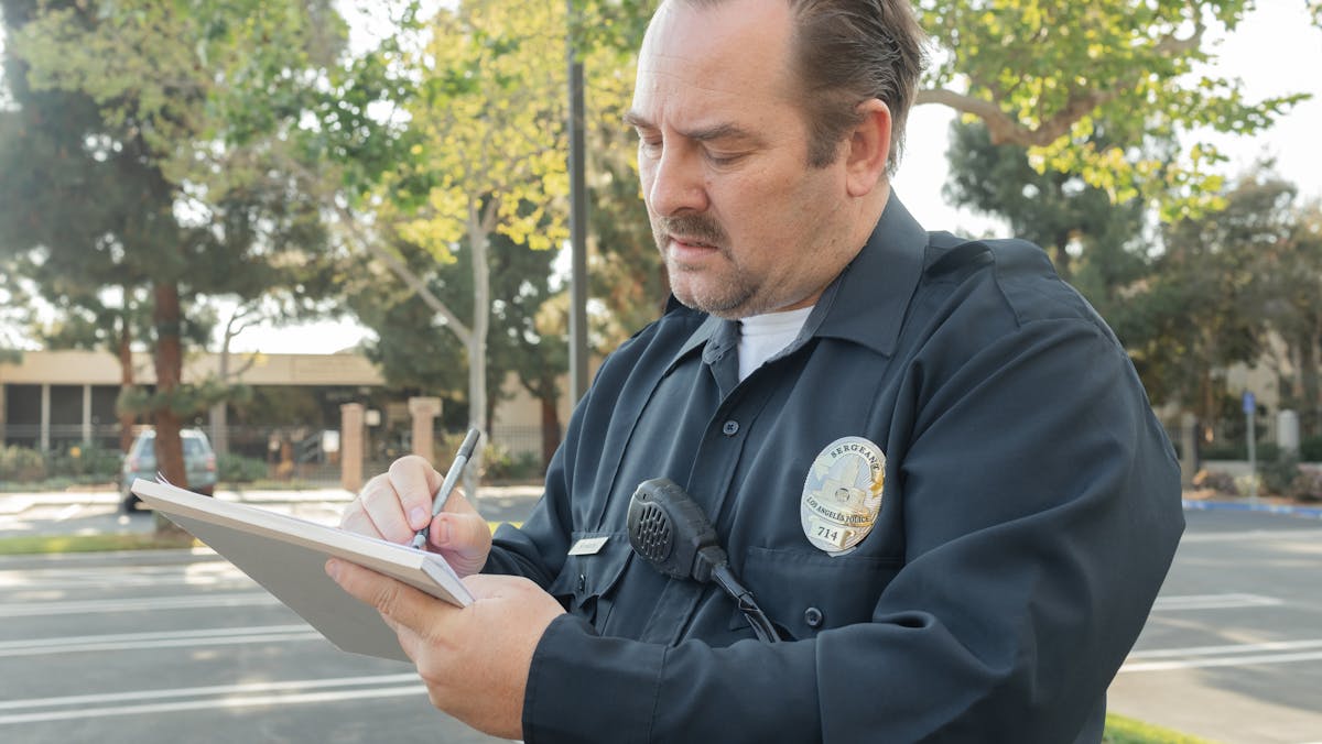 a policeman writing a police report