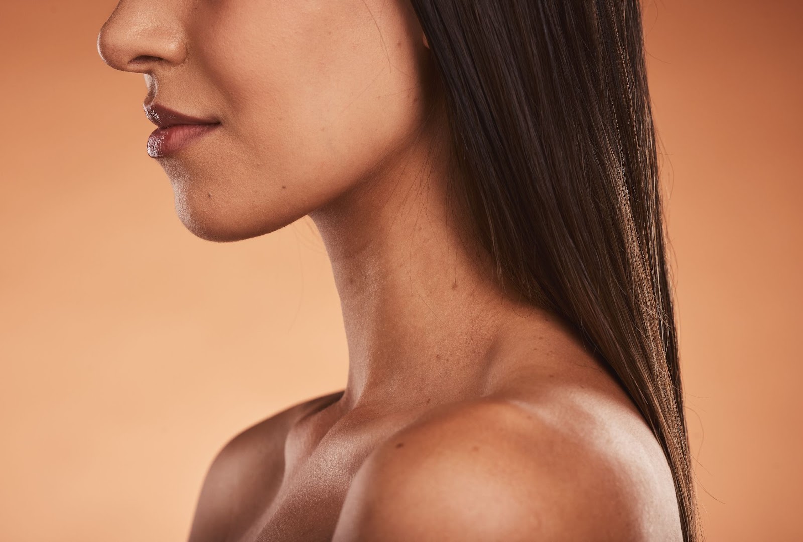 Woman from the shoulders up with healthy skin. 