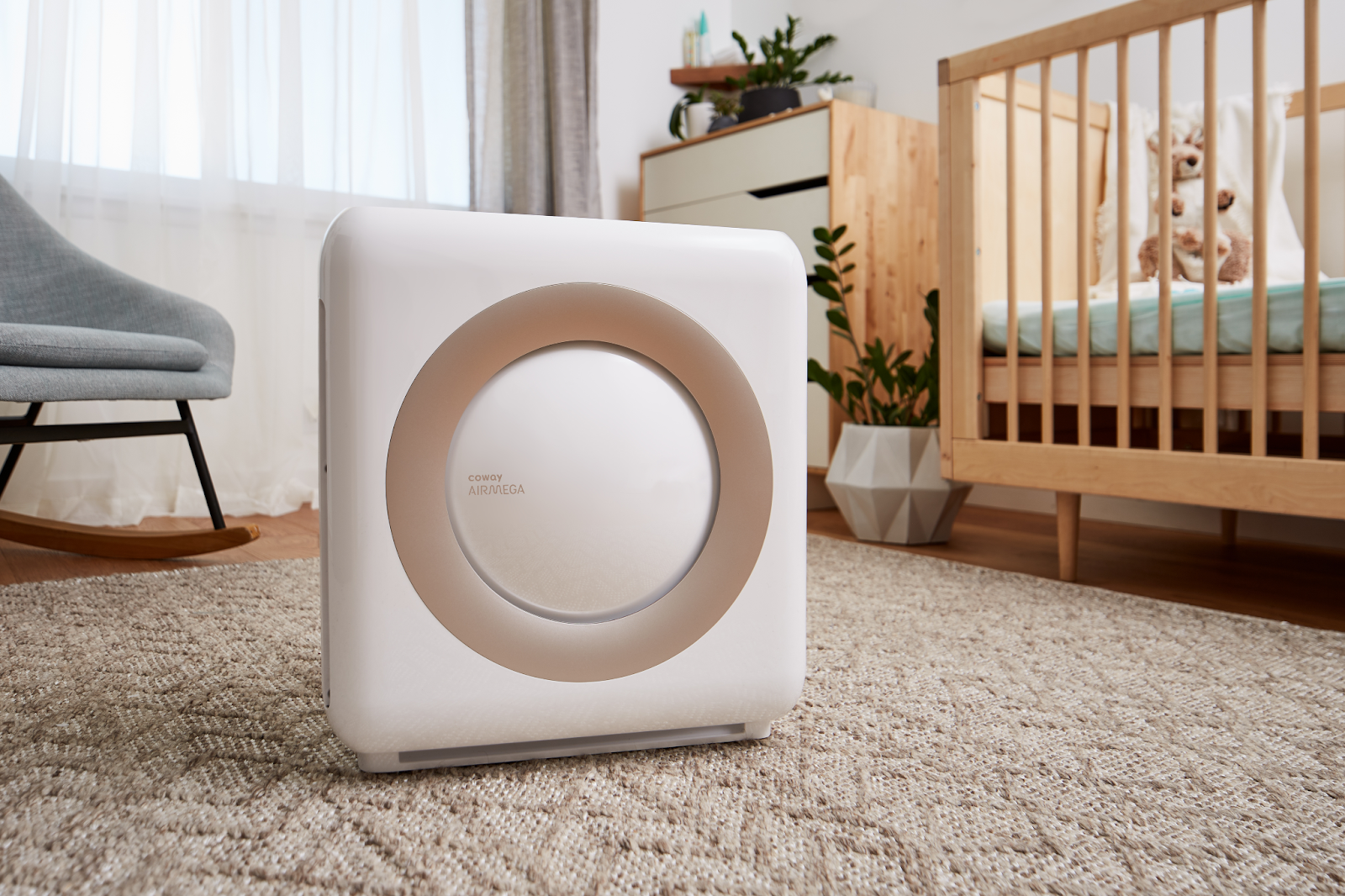 The Airmega Mighty in a child’s room next to a crib.