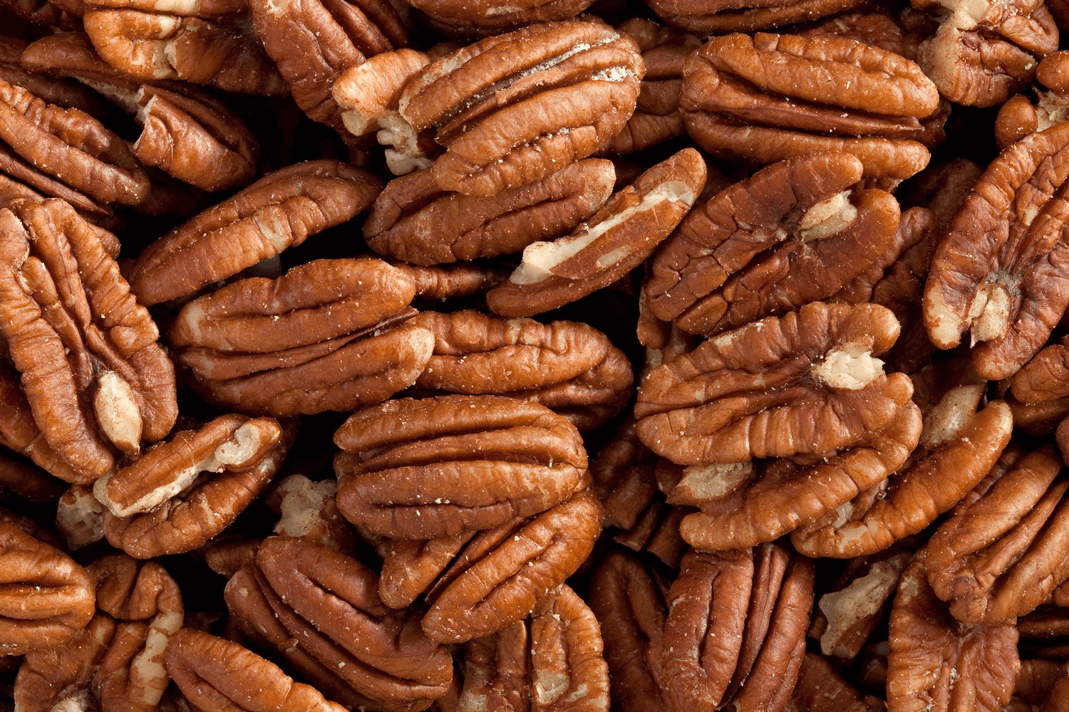 A pile of shelled pecans, a rich source of healthy fats and omega-3s, which support brain health and can be added to smoothies for ADHD.