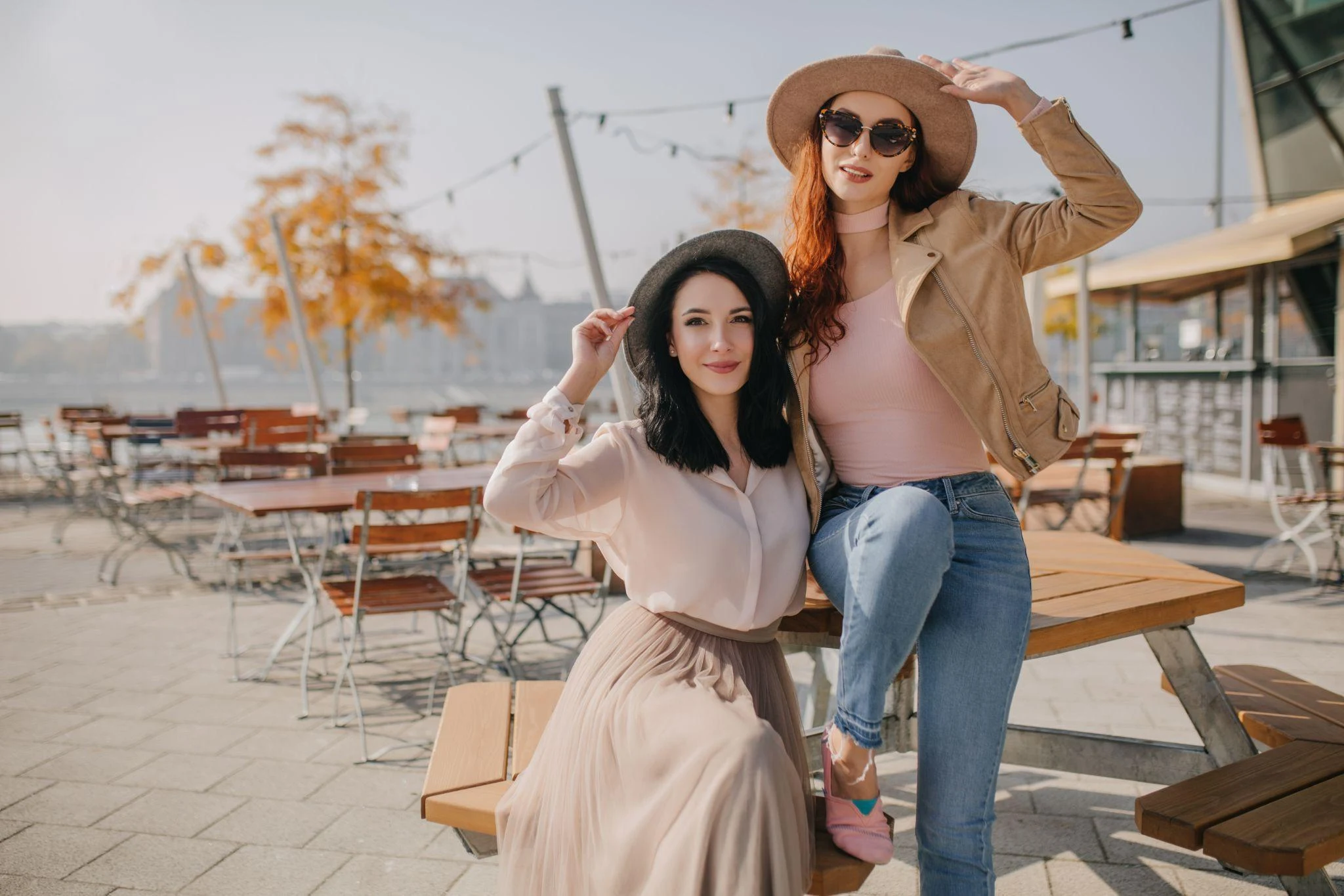 two women in modest clothing sitting in outdoor cafe