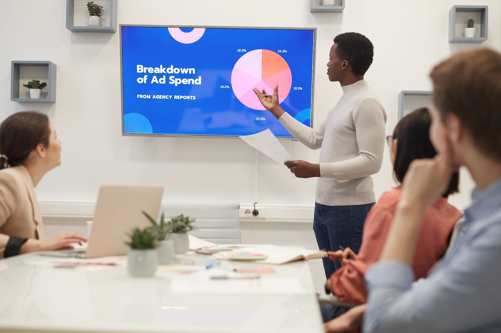 A man making a presentation in the boardroom.