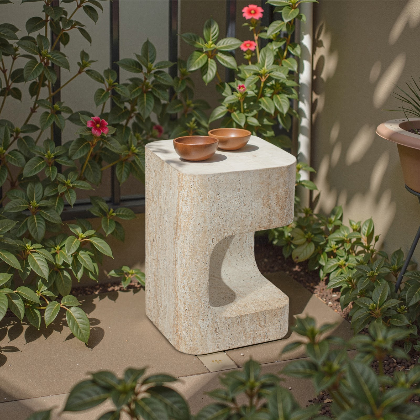 Grover Outdoor Faux Marble Asymmetrical Side Table placed in a garden setting, featuring a sculptural C-shaped design with a travertine-inspired finish—perfect for modern patios or outdoor lounge spaces seeking artistic and functional furniture.