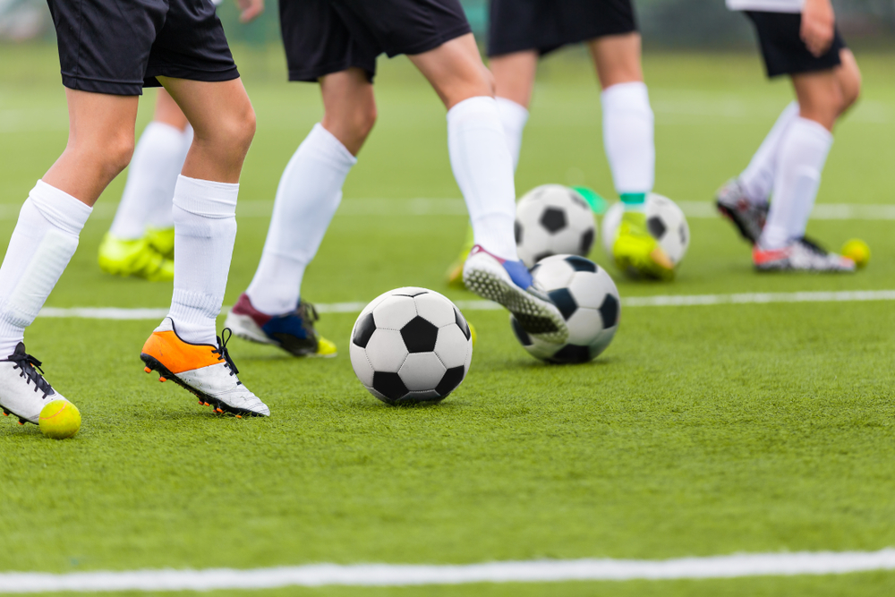 Soccer players conducting soccer passing drills.