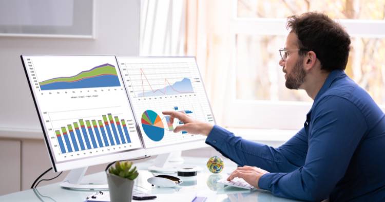 man looking at charts on computer