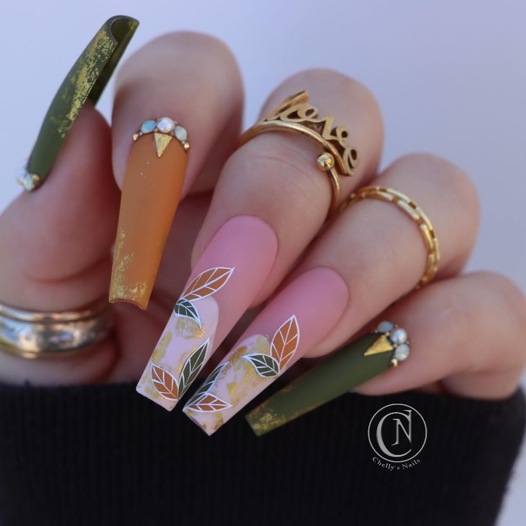 Close-up of hands with fall nail design having Autumn-Themed Nail Piercings