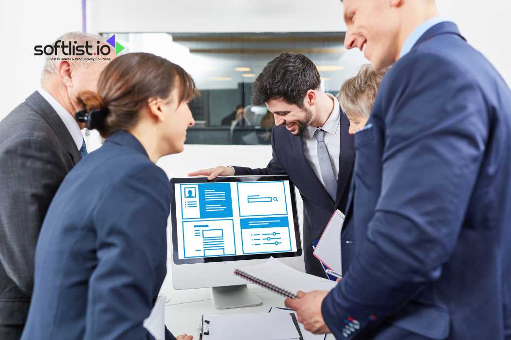 Business team discussing project in front of computer monitor