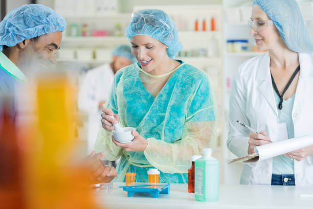 Pharmacists carefully compounding pain medications in a laboratory, measuring and mixing ingredients to create tailored pain relief solutions.







