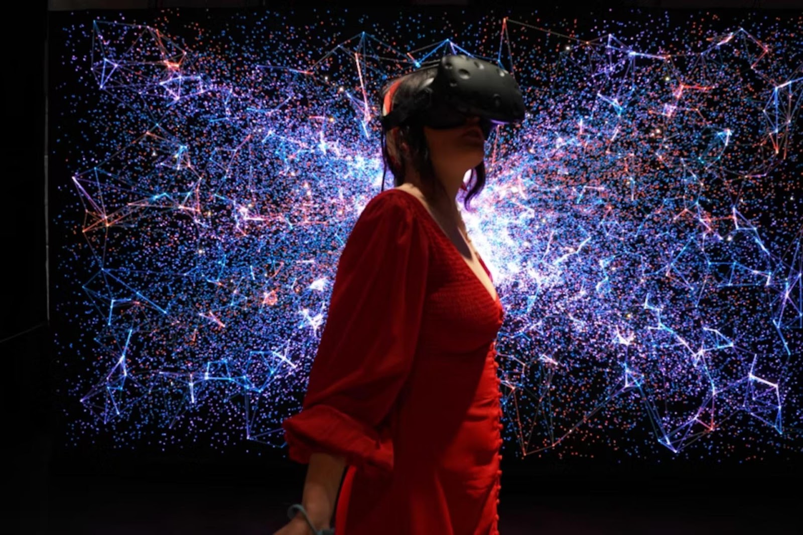 woman in red wearing VR headset with digital background