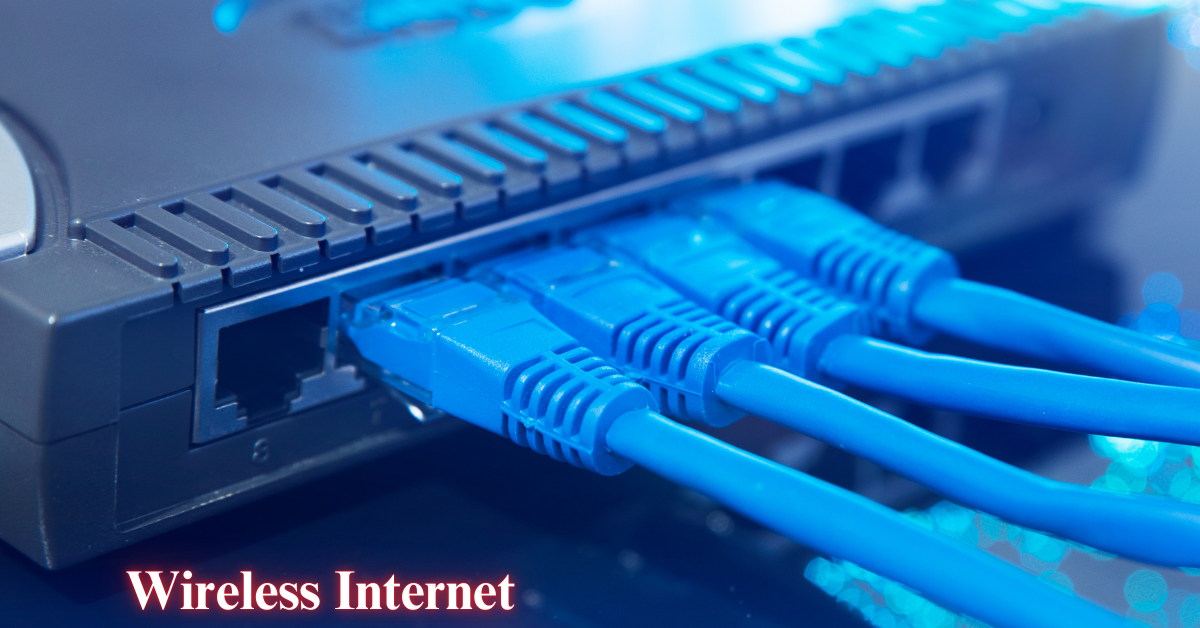 Close-up view of a network router with multiple blue ethernet cables plugged in. The text "Wireless Internet" is displayed in the bottom left corner.