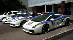 This containan image of four police cars parked in front of a building