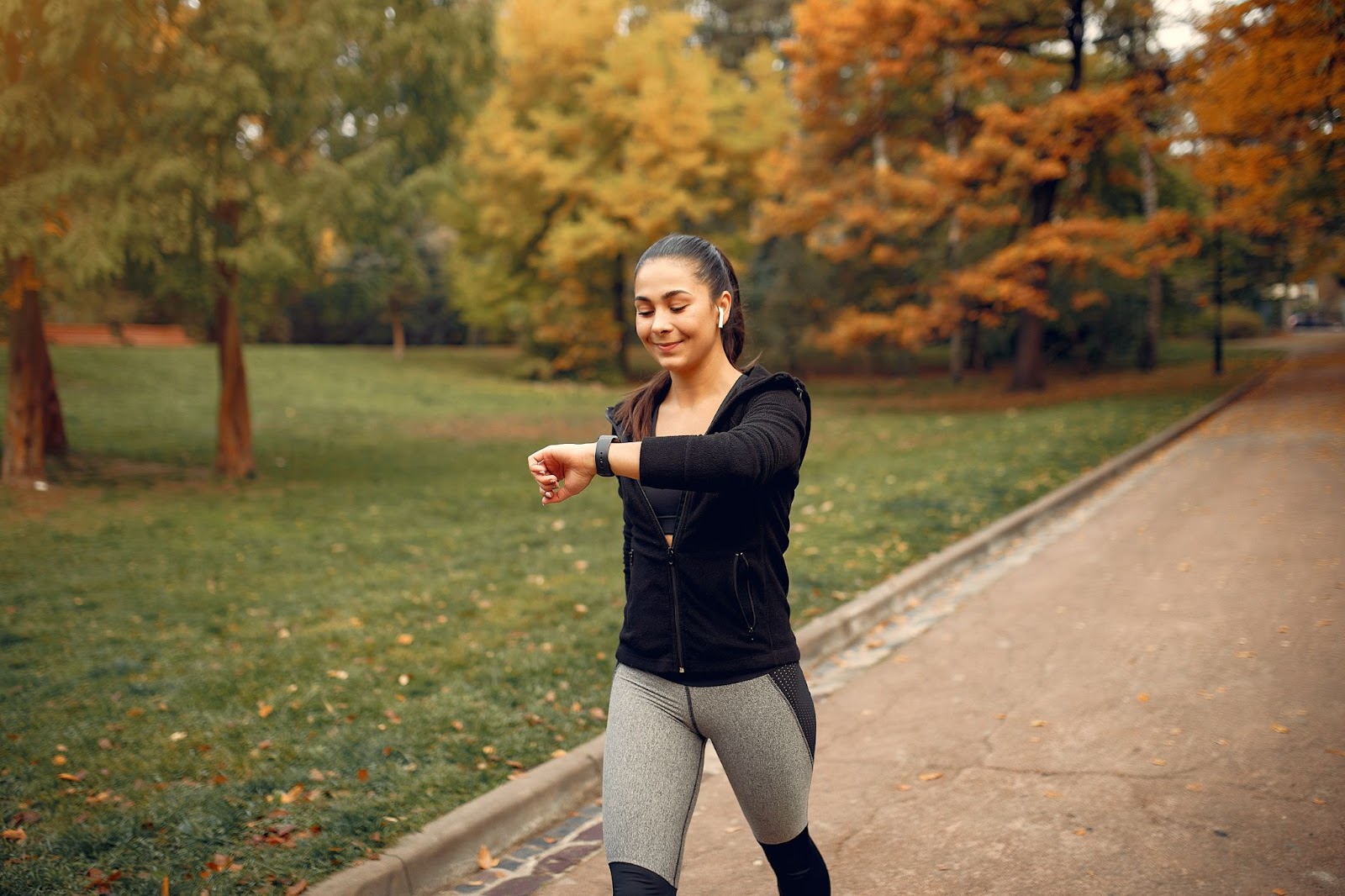 Sports girl in black top training during autumn