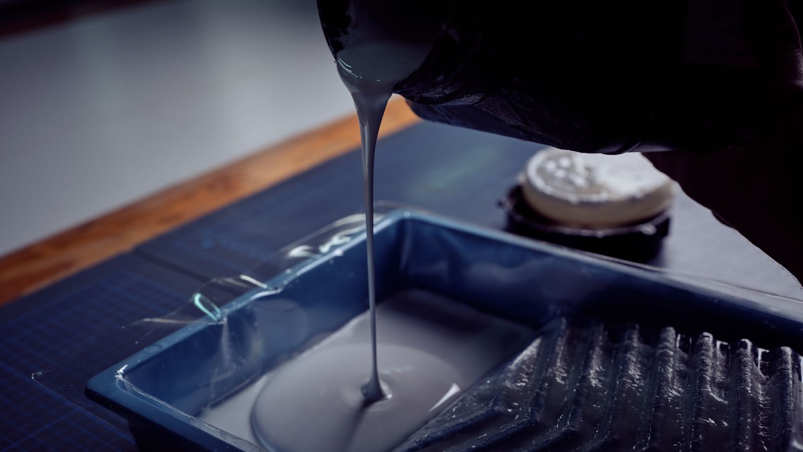 An image of bookbinding glue being poured