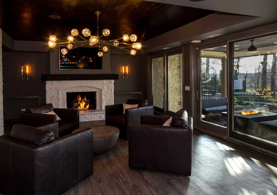 A fireplace built within a free-standing natural stone mantle and elevated front hearth