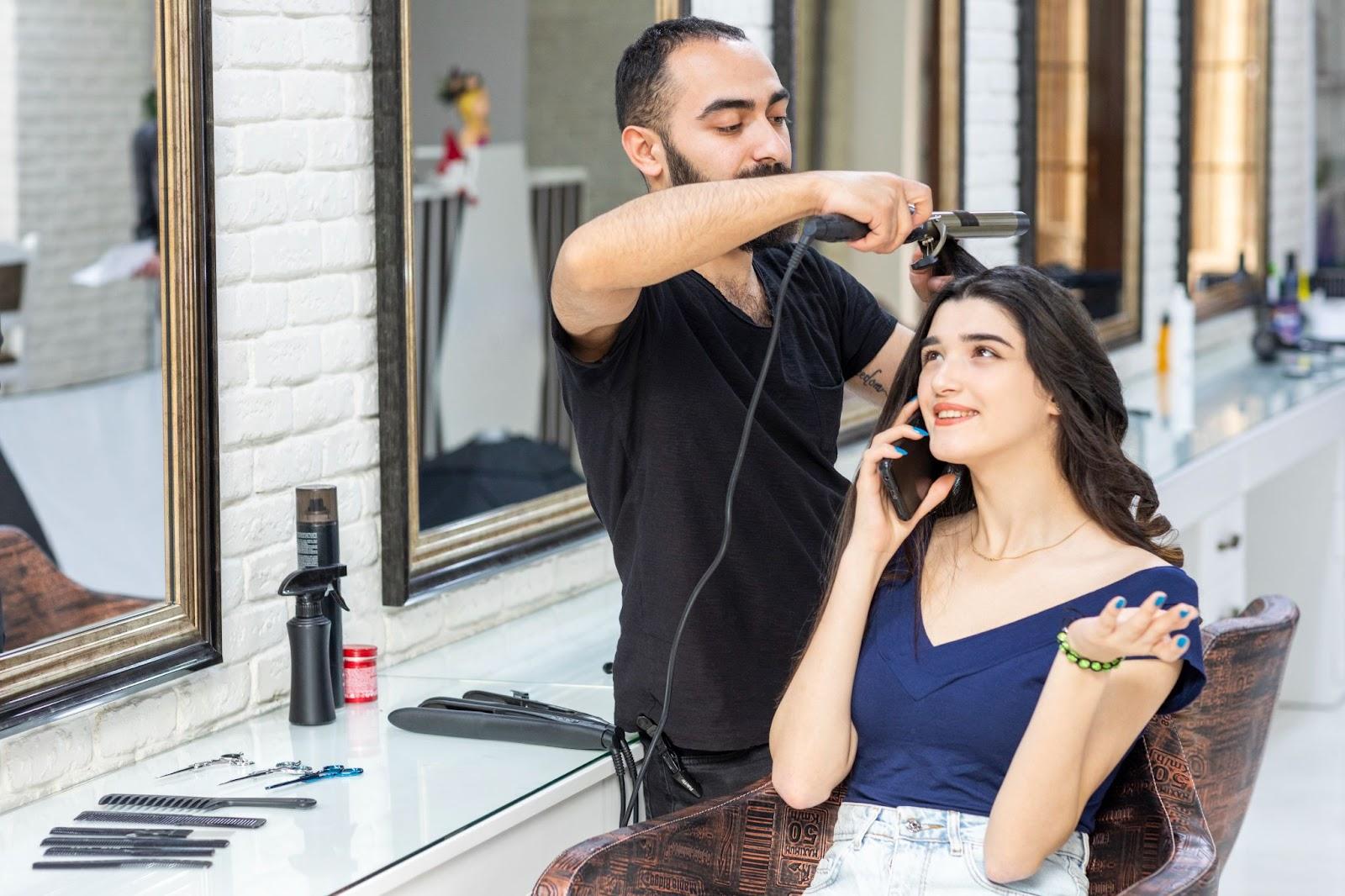 a hair salon client getting her hair curled