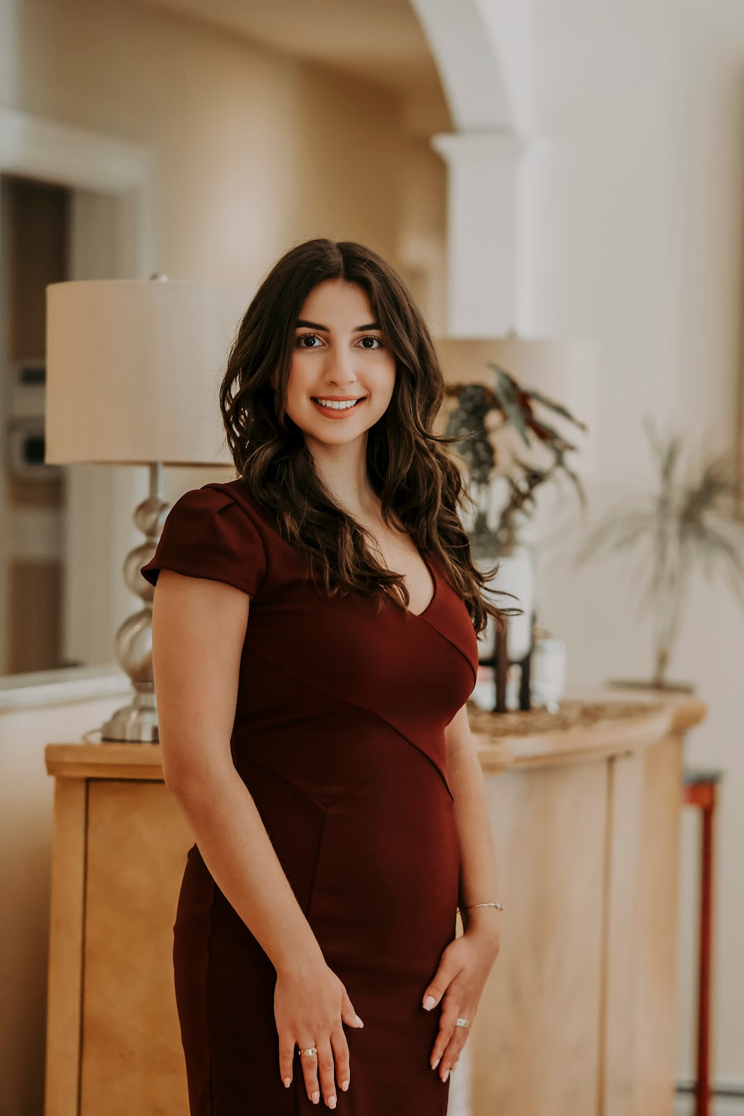 A woman dressed in red dress posing for a picture