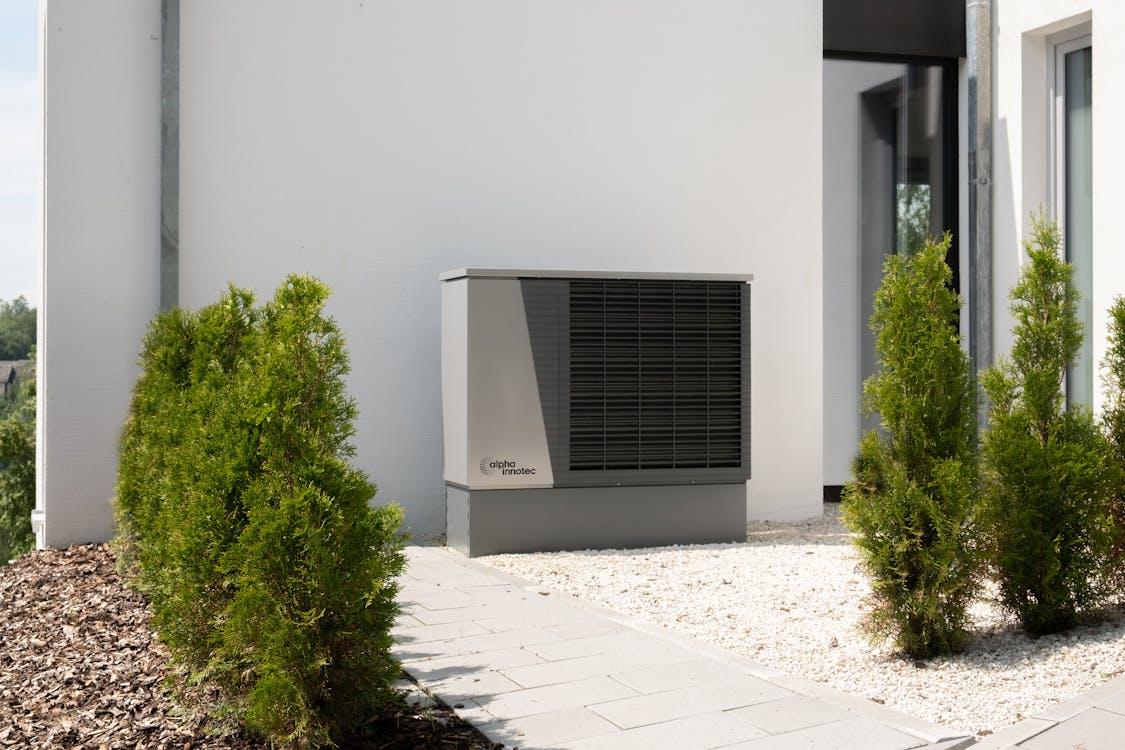 Free Plants near Air Conditioner and Building Wall Stock Photo