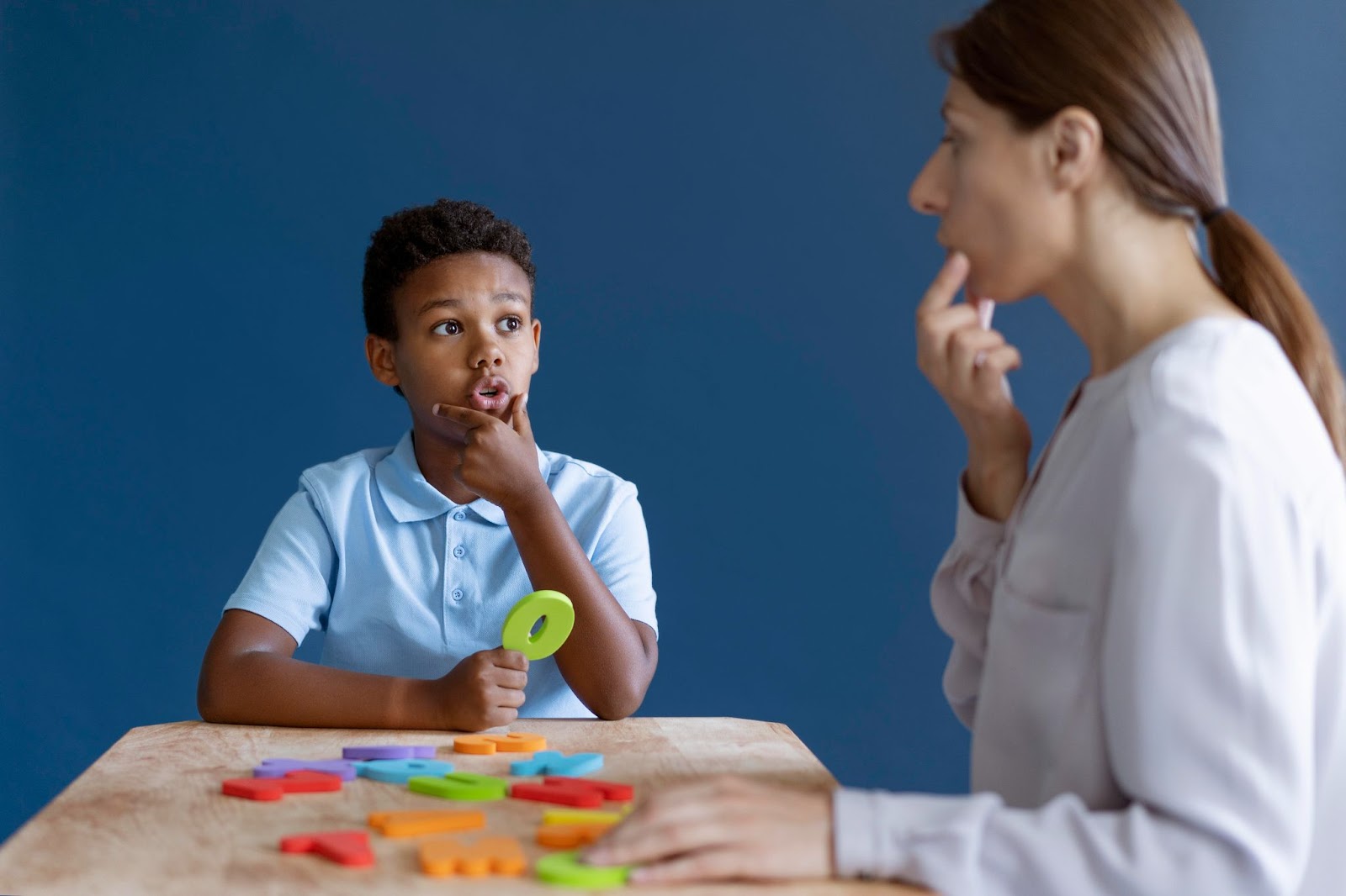 A boy having an occupational therapy session with a psychologist