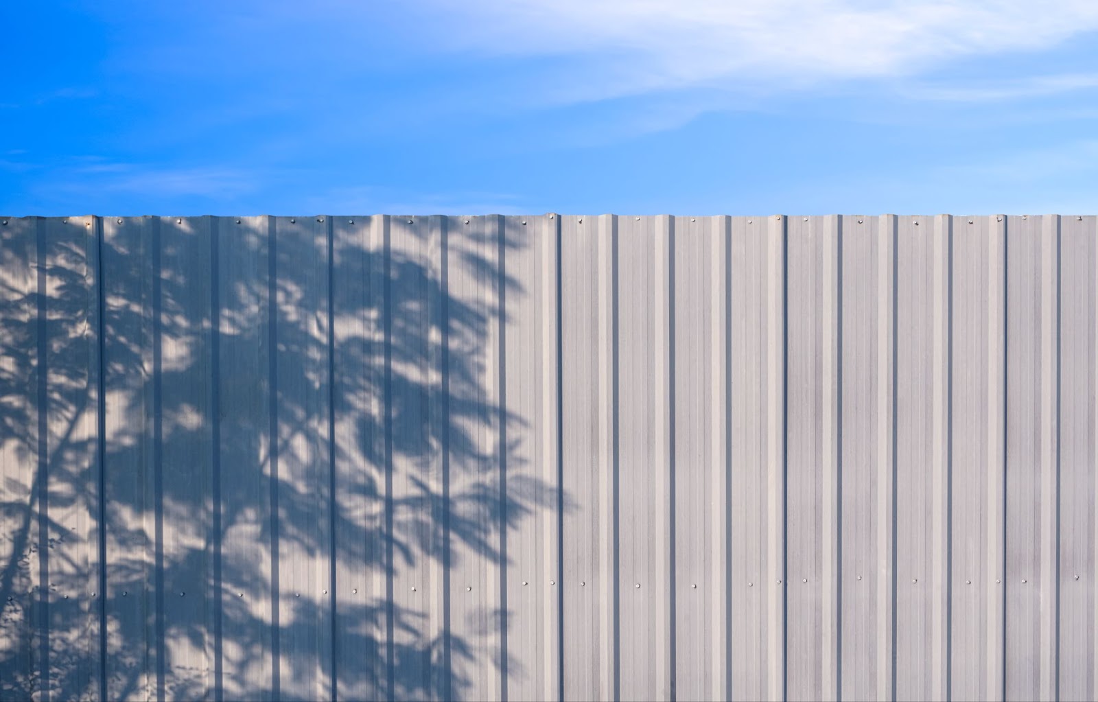 Steel fence with open sky in the background.