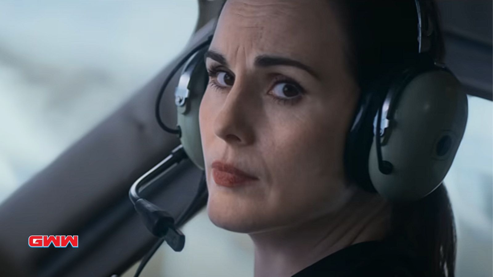 Close up of Michelle Dockery with a serious expression in the helicopter cockpit.