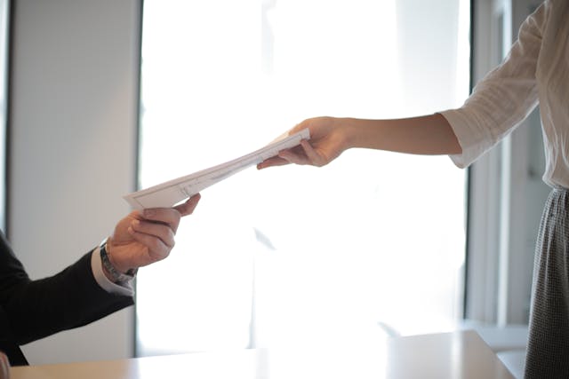 Person passing documents to a tenant