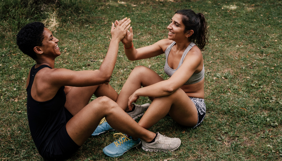 A couple of women sitting on grass giving each other a high five

AI-generated content may be incorrect.