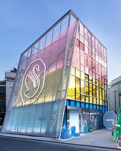 This contain an image of  the Swarovski's Masters Of Light Pop-Up building  it has many different colored glass panels on it's front and side walls