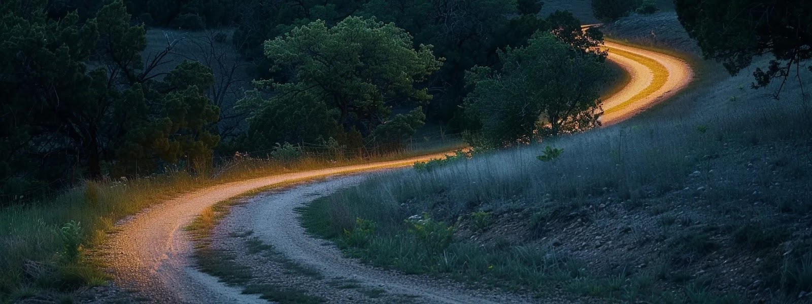 dusk falls over a winding rural road in oklahoma, highlighting the importance of safe nighttime driving practices.