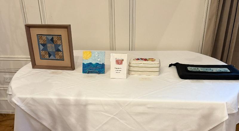 A table with a white tablecloth and a picture and a bag

AI-generated content may be incorrect.