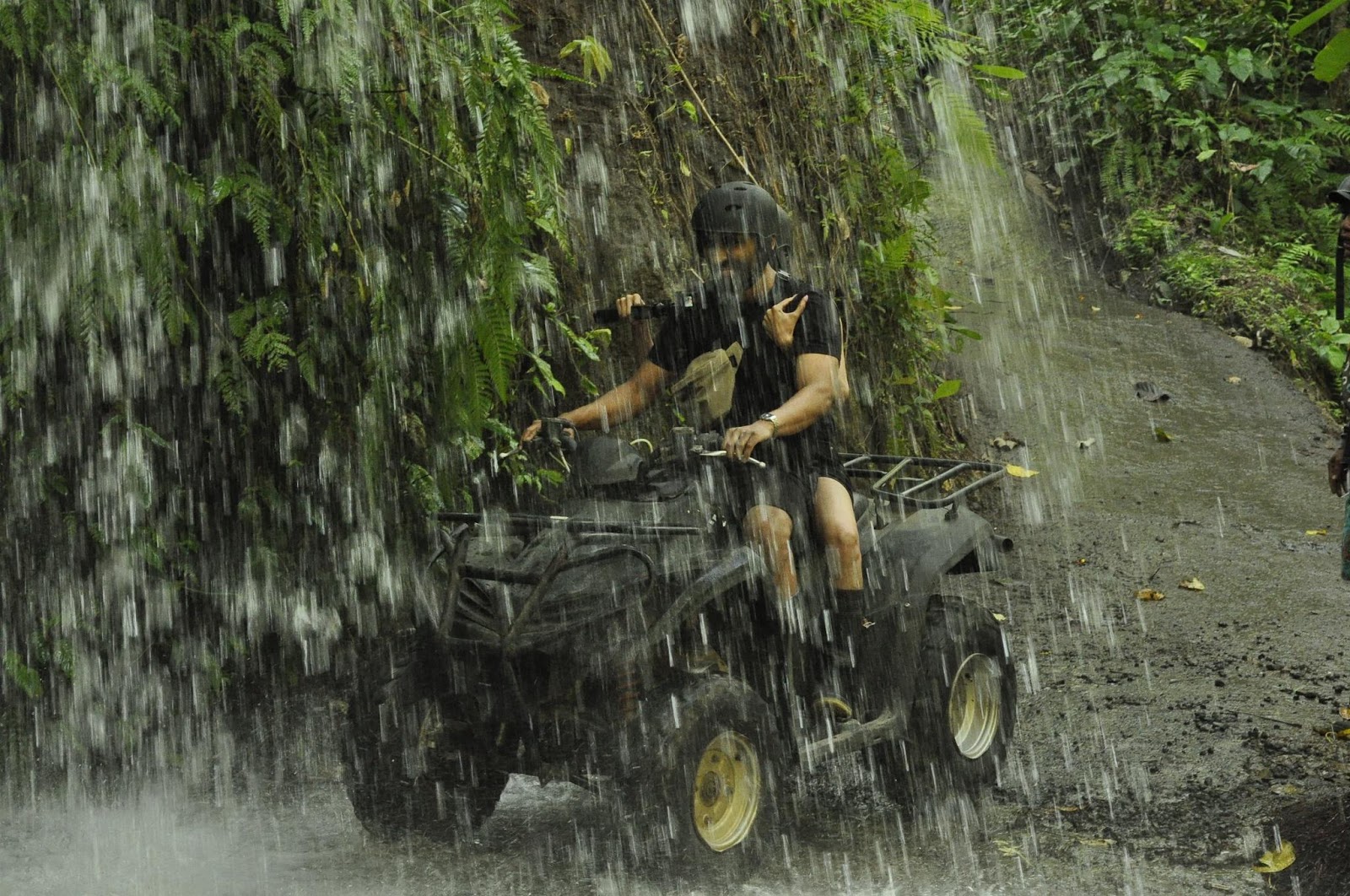 riding an atv through a waterfall in bali 